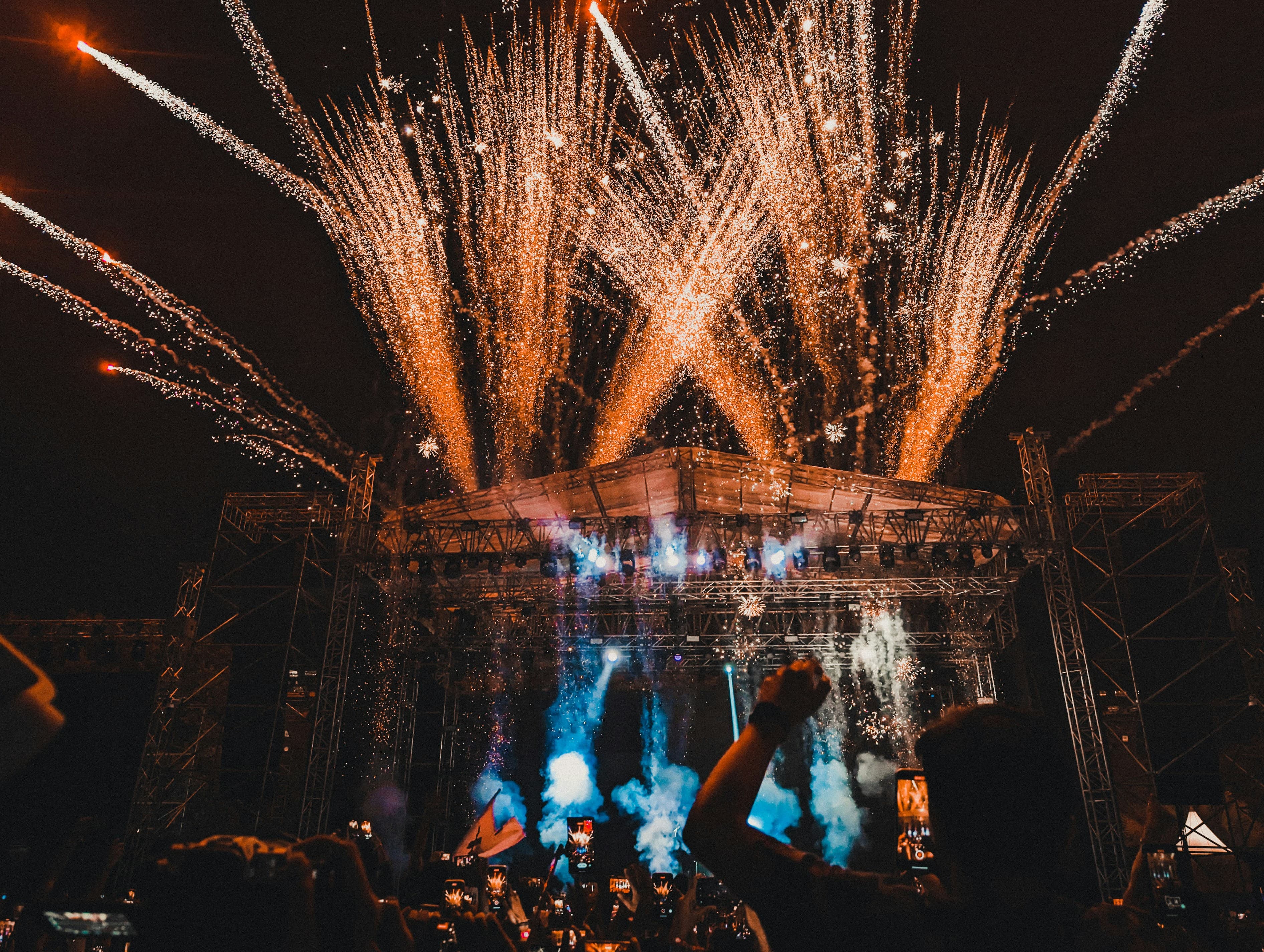 Fireworks burst over concert festival stage